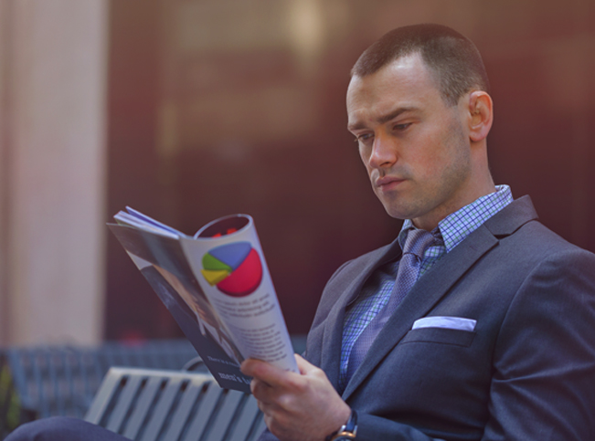 businessman reading news magazine